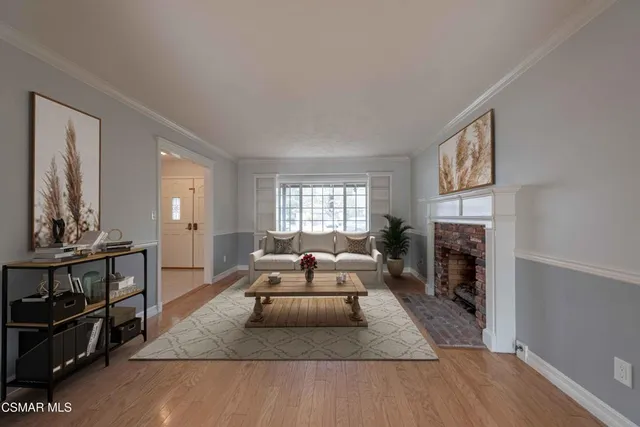 a living room with furniture fireplace and window