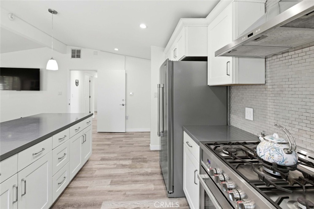 301 West Ashby Street Azusa, CA 91702 - Photo 46 of 75 a kitchen with stainless steel appliances granite countertop a stove and a refrigerator