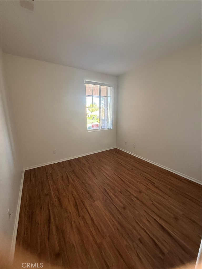 8783 Hunt Canyon Road Corona, CA 92883 - Photo 13 of 24 an empty room with wooden floor and windows