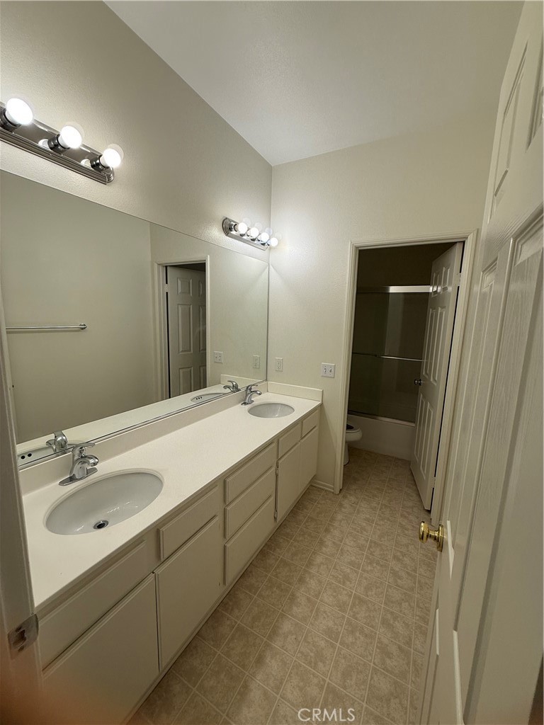 8783 Hunt Canyon Road Corona, CA 92883 - Photo 16 of 24 a bathroom with a double vanity sink mirror and shower