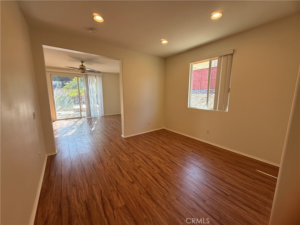 8783 Hunt Canyon Road Corona, CA 92883 - Photo 18 of 24 an empty room with wooden floor and windows