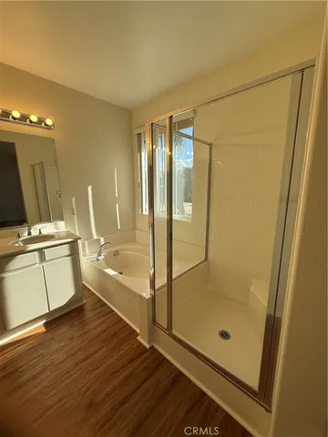 a bathroom with a glass shower door and a bathtub