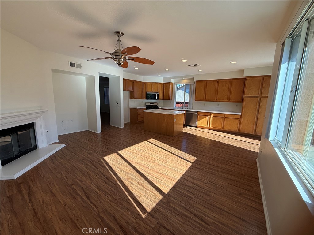 8783 Hunt Canyon Road Corona, CA 92883 - Photo 4 of 24 a living room with stainless steel appliances furniture a rug and a kitchen view
