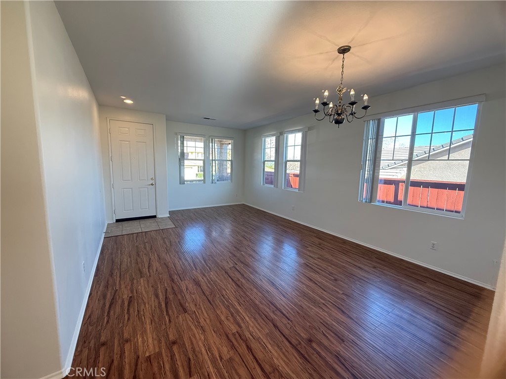 8783 Hunt Canyon Road Corona, CA 92883 - Photo 7 of 24 an empty room with wooden floor and windows