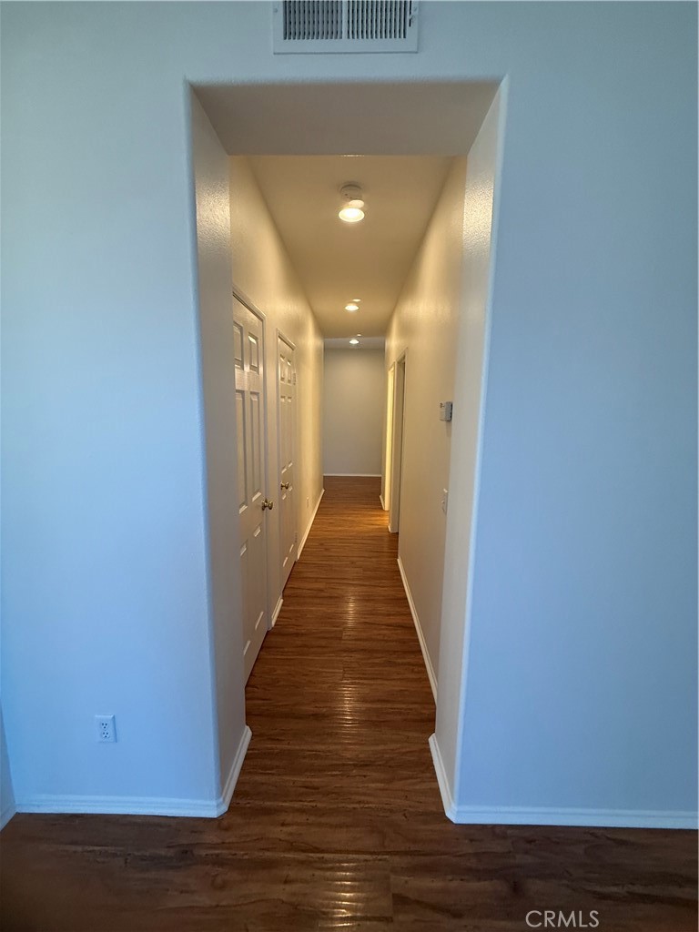 8783 Hunt Canyon Road Corona, CA 92883 - Photo 8 of 24 a view of a hallway with wooden floor