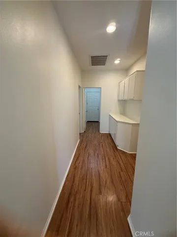 a view of hallway with wooden floor