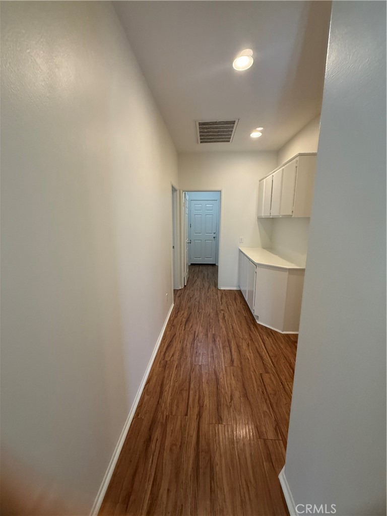 8783 Hunt Canyon Road Corona, CA 92883 - Photo 9 of 24 a view of hallway with wooden floor