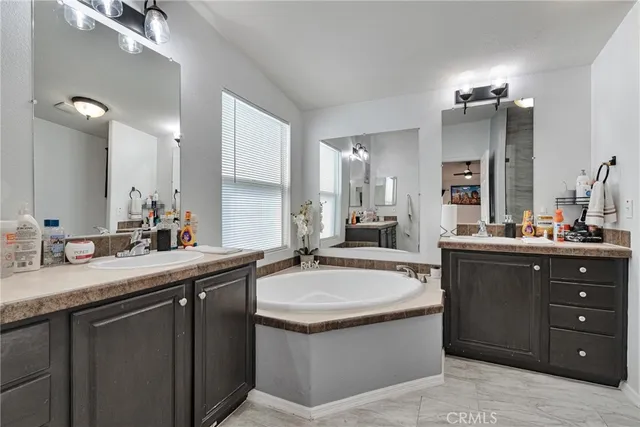 a bathroom with a sink double vanity and a mirror