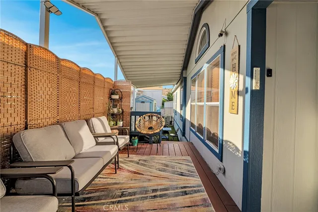 a balcony with wooden floor stairs and a potted plant