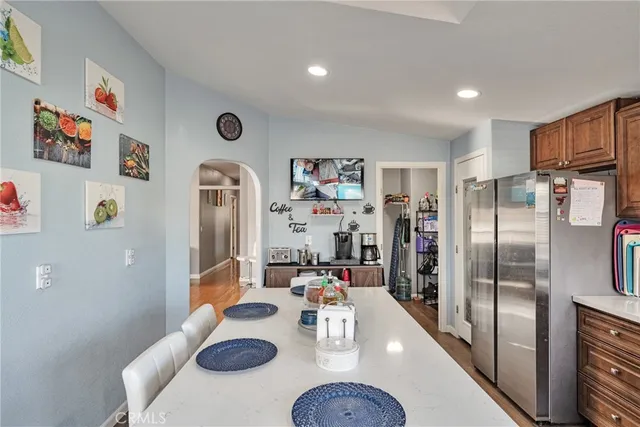 a kitchen with stainless steel appliances granite countertop a refrigerator and microwave