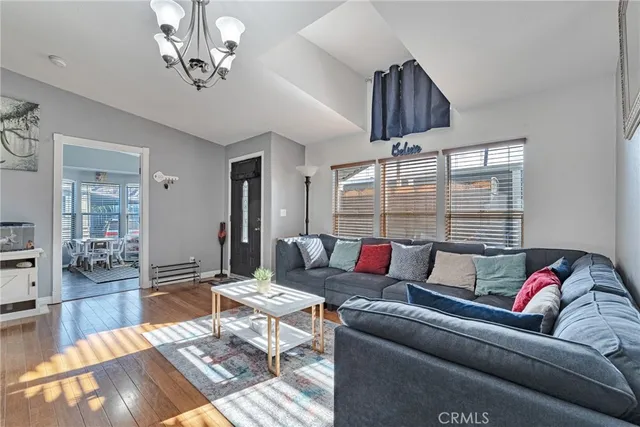 a living room with furniture a rug and a chandelier