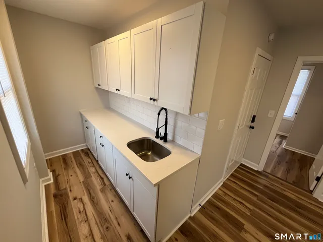 a bathroom with a sink and a window