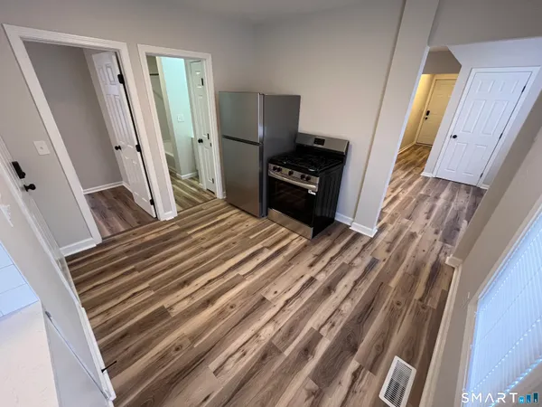 a bedroom with a bed and a flat tv screen on dresser