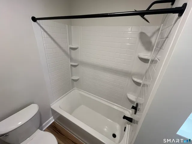 a bathroom with a white sink and a shower
