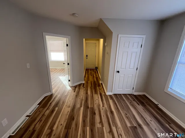 a view of a room with wooden floor and a window