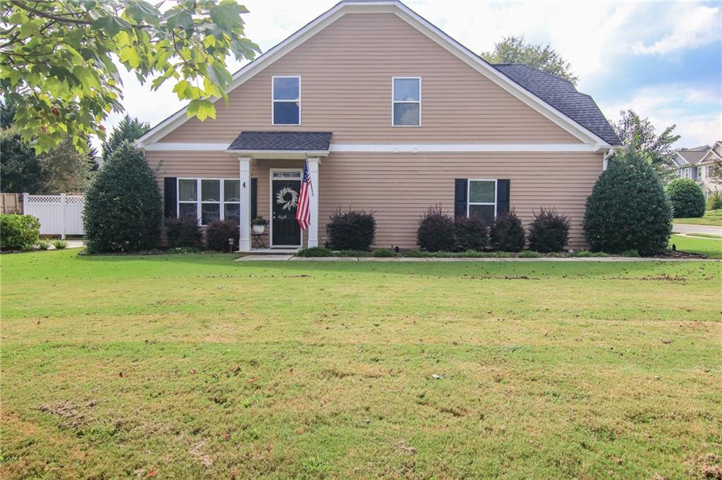 a front view of house with yard and green space