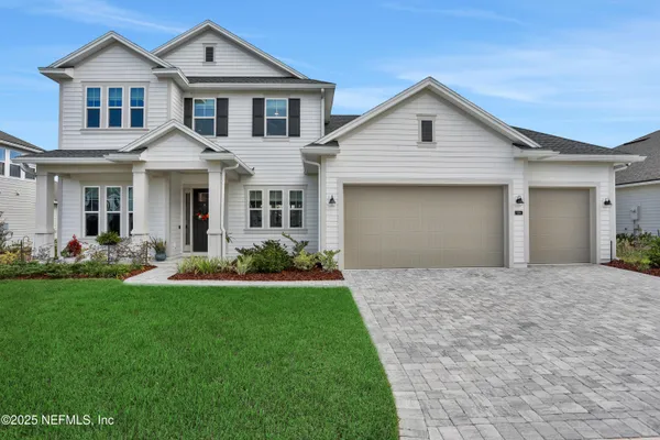 a front view of a house with a yard and garage