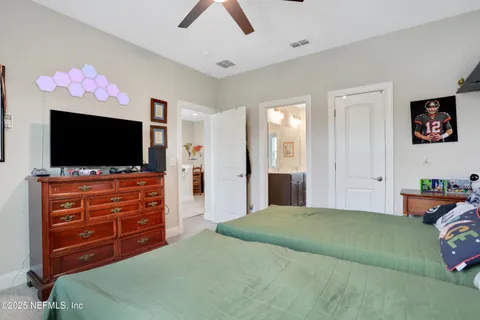 a bedroom with a bed and flat screen tv