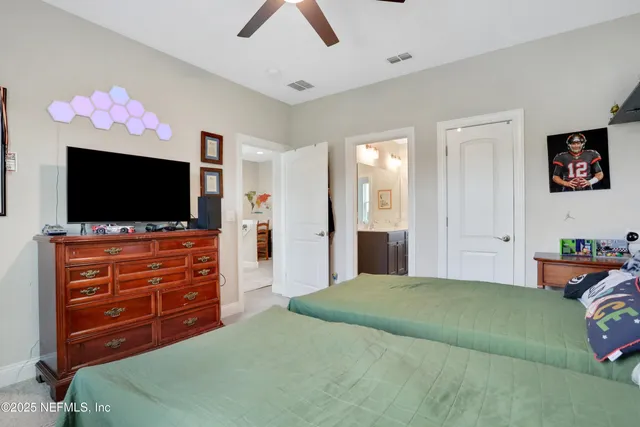 a bedroom with a bed and flat screen tv