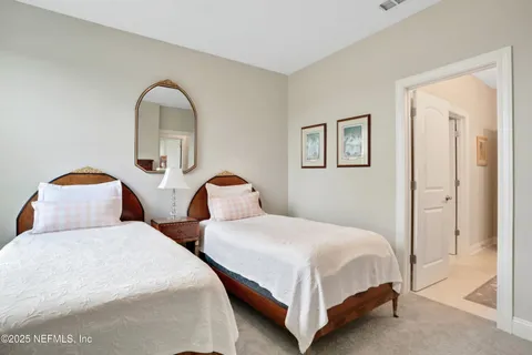 a bedroom with two beds and white walls