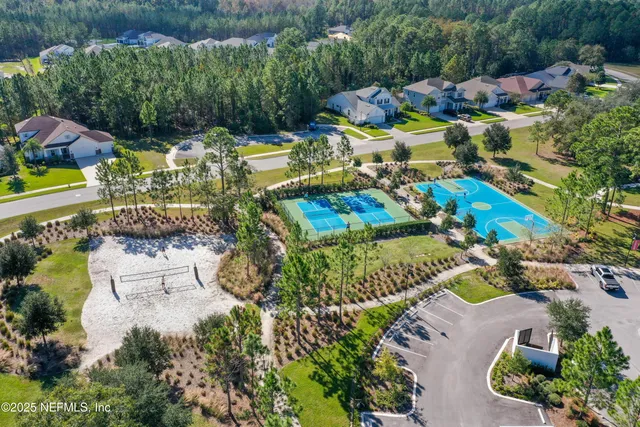 an aerial view of a house with a garden and swimming pool