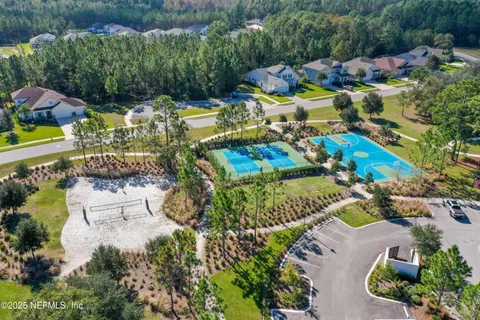 an aerial view of a house with a garden and swimming pool