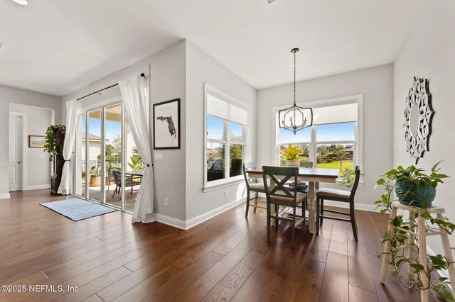 a view of a dining room with furniture window and wooden floor