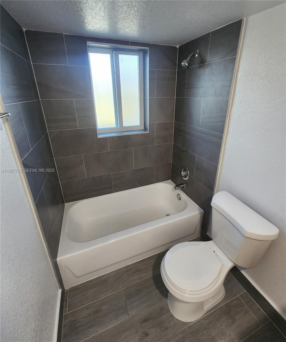 10900 Southwest 196th Street, Unit 213 Cutler Bay, FL 33157 - Photo 14 of 15 a bathroom with a toilet and bathtub