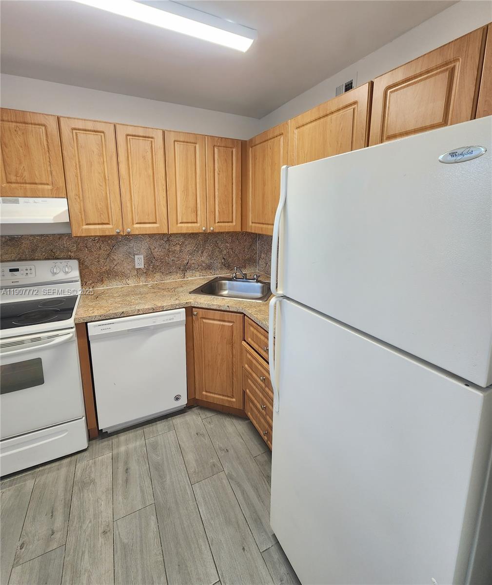 10900 Southwest 196th Street, Unit 213 Cutler Bay, FL 33157 - Photo 2 of 15 a white refrigerator freezer sitting inside of a kitchen