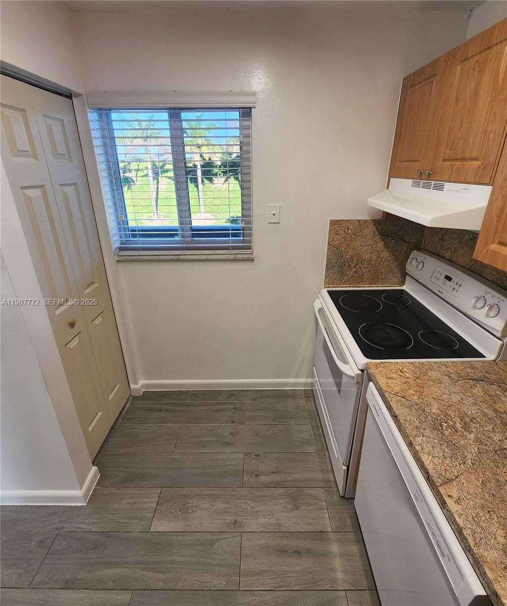 10900 Southwest 196th Street, Unit 213 Cutler Bay, FL 33157 - Photo 4 of 15 a kitchen with a sink a stove and a window