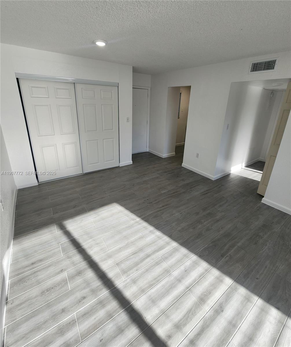 10900 Southwest 196th Street, Unit 213 Cutler Bay, FL 33157 - Photo 6 of 15 a view of an empty room
