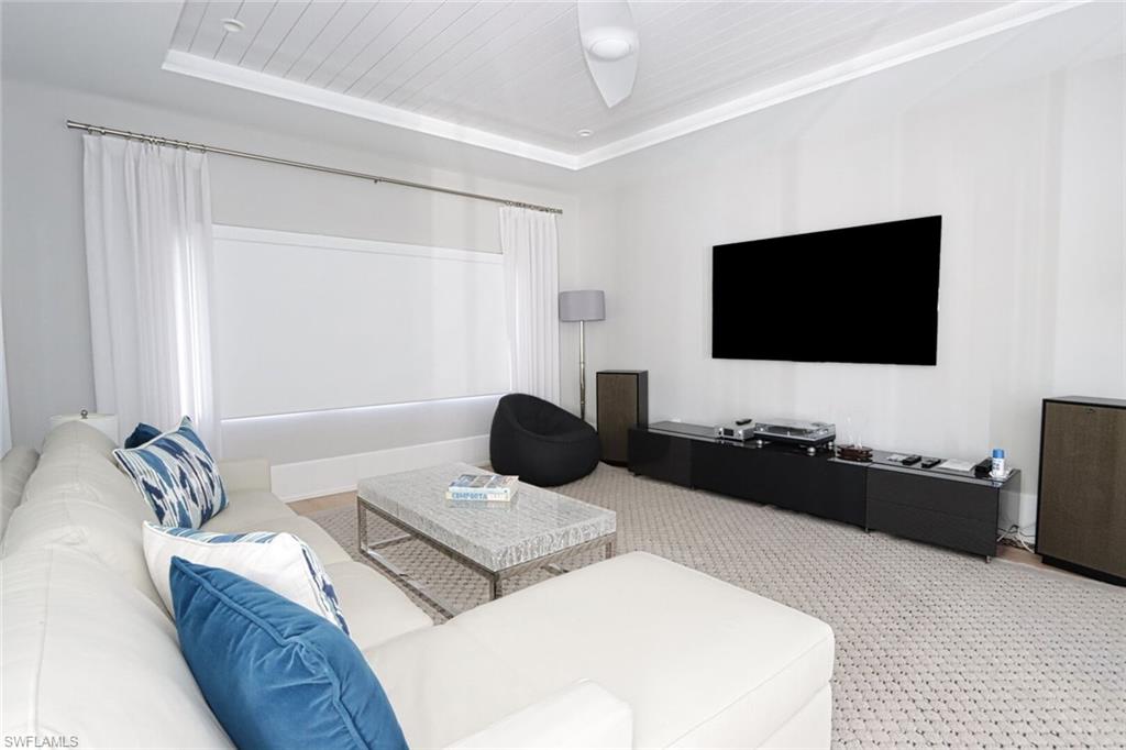 675 2nd Street South Naples, FL 34102 - Photo 28 of 41 a living room with furniture and a flat screen tv