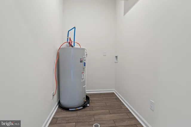 a view of a hallway with wooden floor and closet