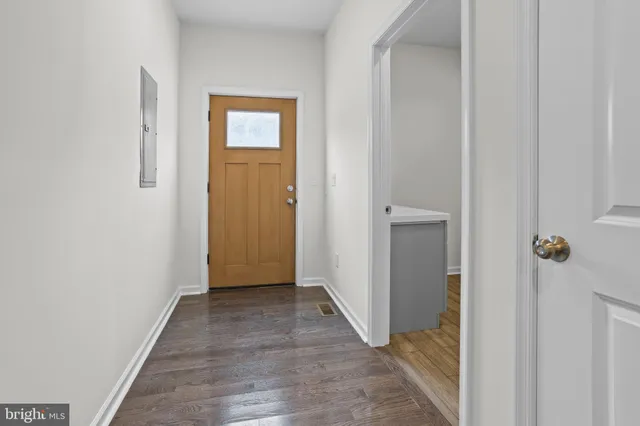 a kitchen with cabinets stainless steel appliances and wooden floor