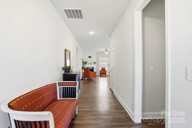 a view of a hallway with seating space