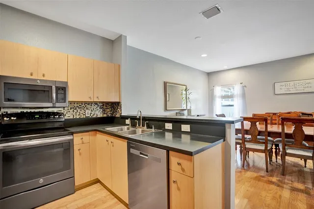 a kitchen with granite countertop a sink and a stove top oven