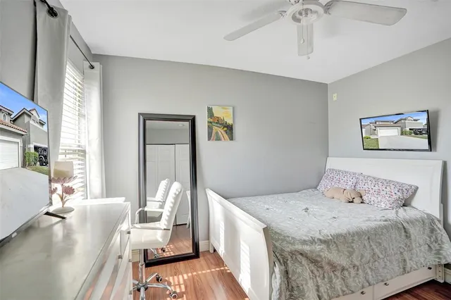 a bedroom with a bed and wooden floor