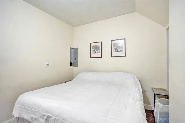 a bedroom with a bed and painting on the wall