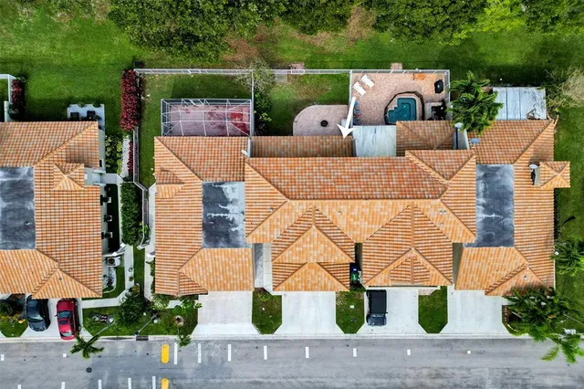 an aerial view of a house with garden space and street view