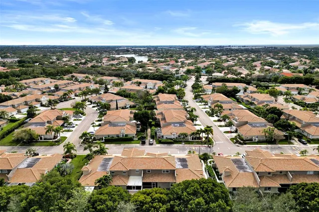 an aerial view of residential houses with city view