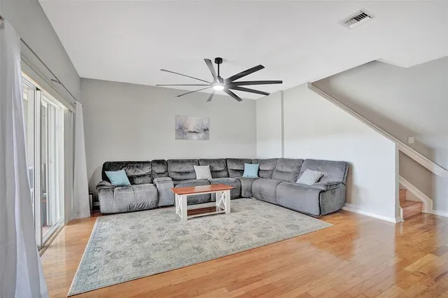 a living room with furniture and a wooden floor