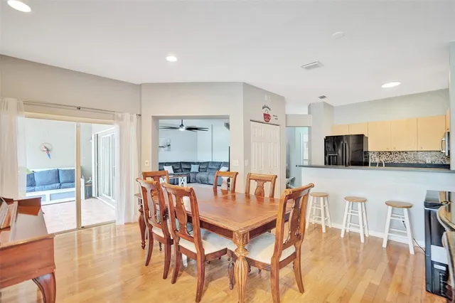 a dining room with furniture and wooden floor