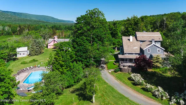 an aerial view of a house with a garden and trees