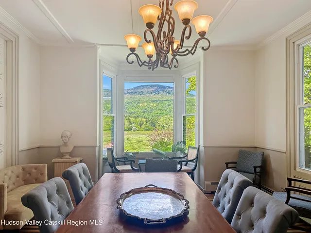 a living room with furniture a large window and a fireplace