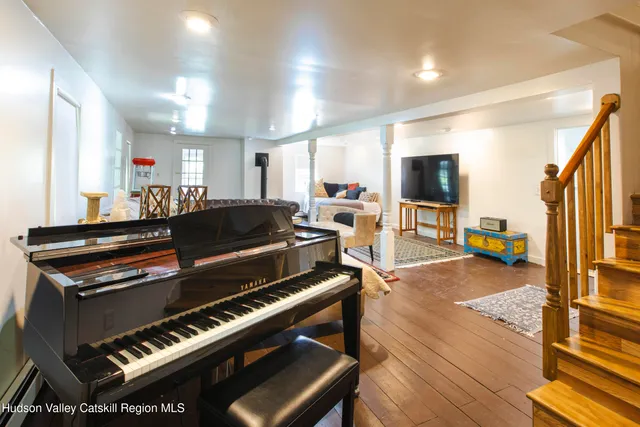 a view of a dining room with furniture window wooden floor and front door