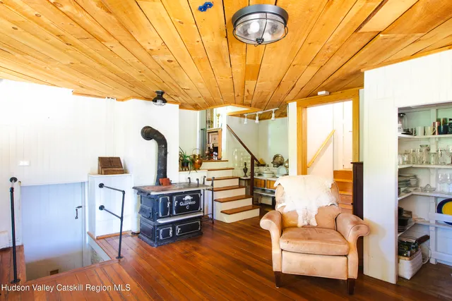 a kitchen with a sink a stove and wooden cabinets