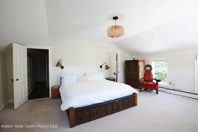 a bed room with a bed and a television