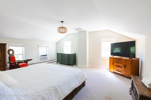 a large bed sitting in a bedroom next to a window