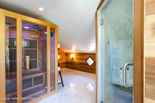 a bathroom with a sink a toilet a mirror and tub