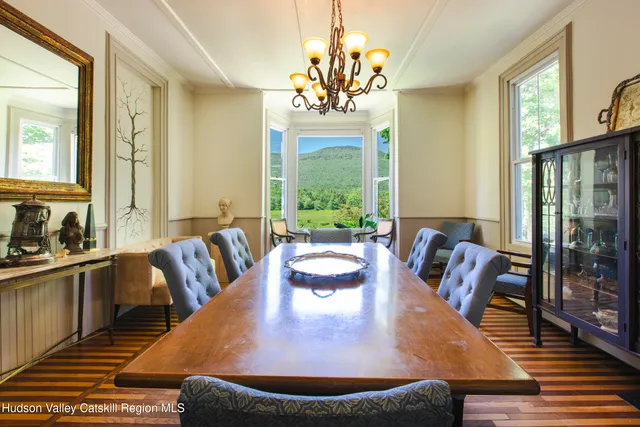 a dining room with furniture a chandelier and wooden floor